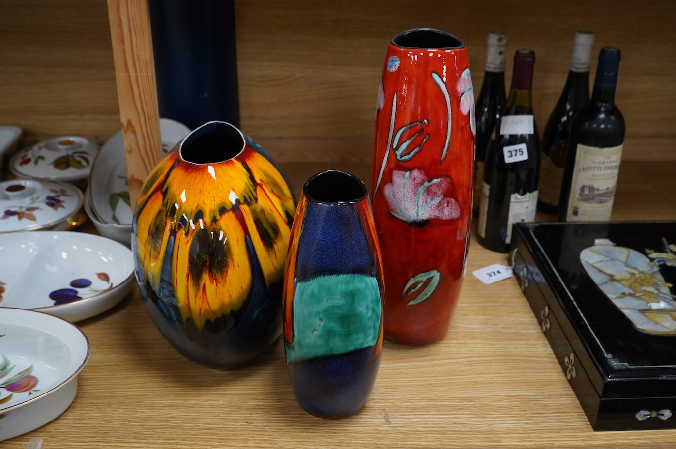 A Poole Purse vase and two Manhattan vases including a ‘daisy’ example, largest 37cm high. Condition - good